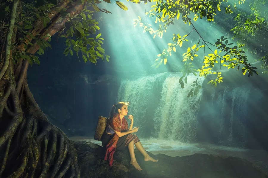 woman sitting near waterfalls in Phnom Kulen, Cambodia