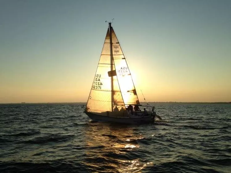 capturing a sunset on a lovely sailboat.